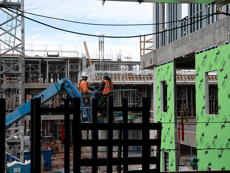 Workers on a lift of the construction site