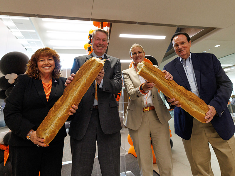 Clary, Lusk, Shrum and Harrel breaking bread during grand opening