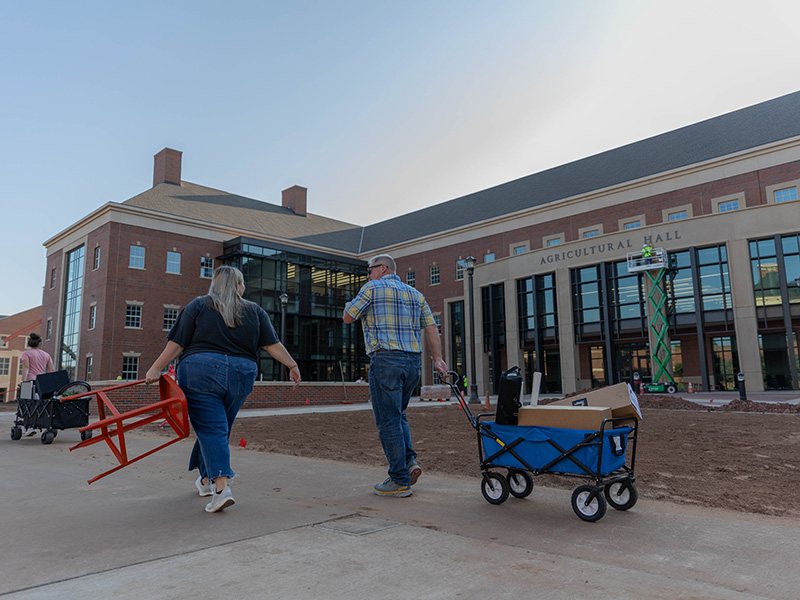 Faculty and staff moving items into new building
