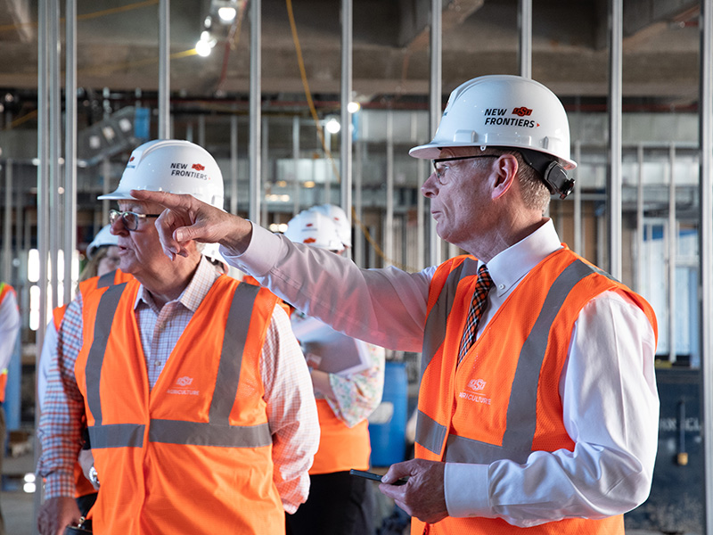Tom Coon points to an area of new building
