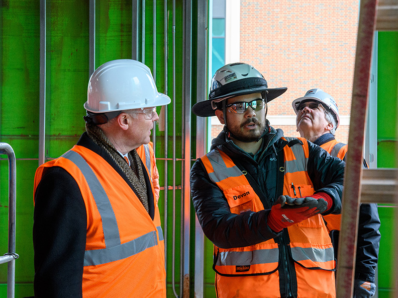 Construction worker talks about features of the new building