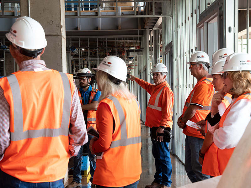 Participants getting a tour of inside the New Frontiers building