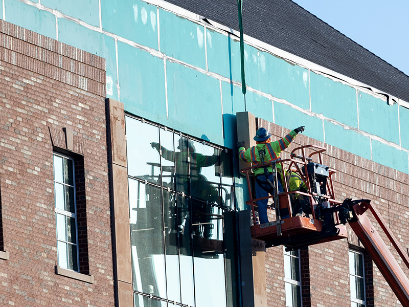 construction worker directing crane operator