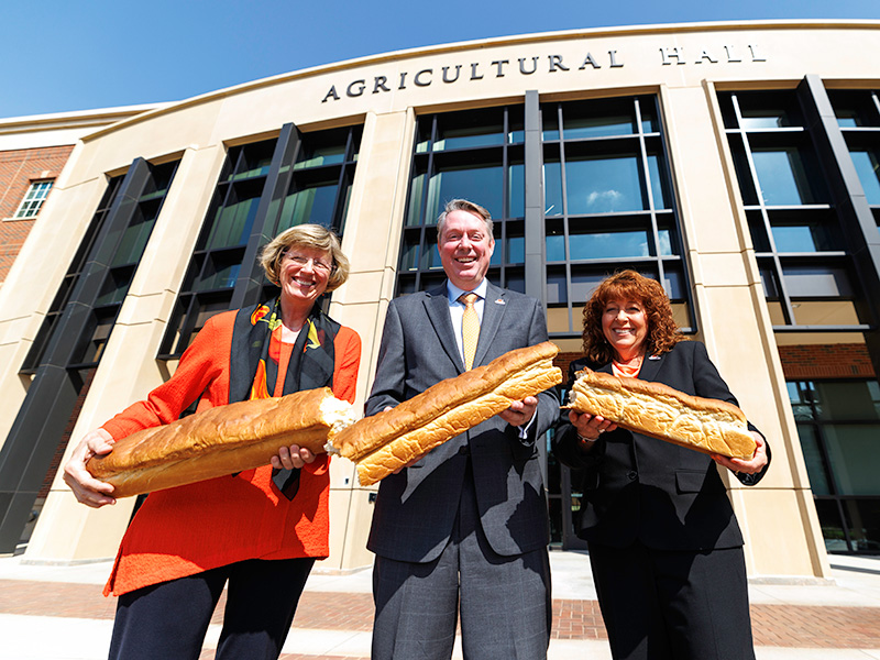 Doye, Lusk and Clary holding broken bread during grand opening Doye, Lusk and Clary holding broken bread during grand opening